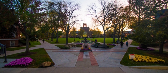 Image taken at dusk of the St. Ignatius statue and quad from the front steps of the Student Center 