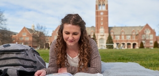 Student Reading on Quad