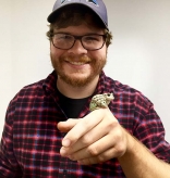 Daniel Paluh '14 with a frog on his hand