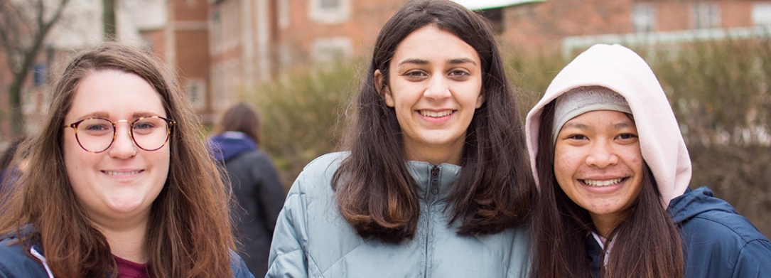 group of female students smiling outside