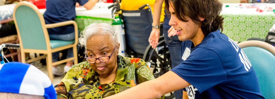 elderly woman playing bingo with student