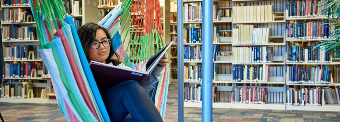 student reading book in library