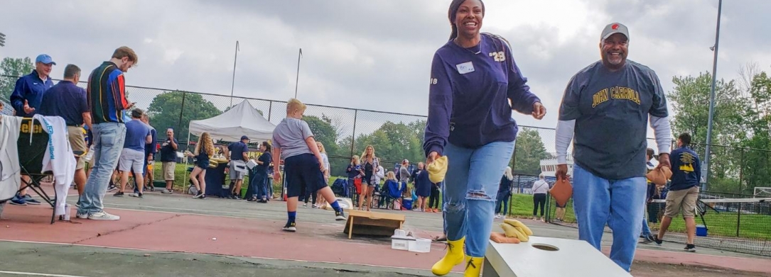 2 people playing cornhole