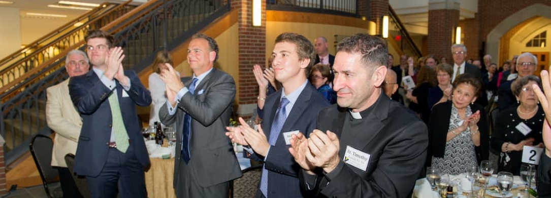 Fr. Kesicki andaudience clapping at Alumni Awards Dinner