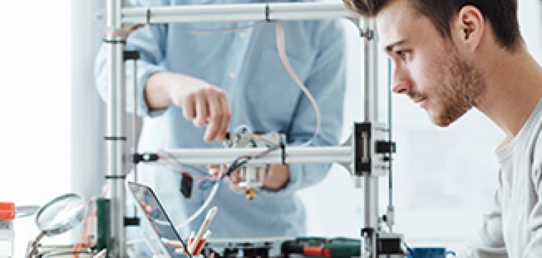 Two males working on a computer science project together