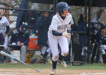 Quinn running to first base after hitting a softball