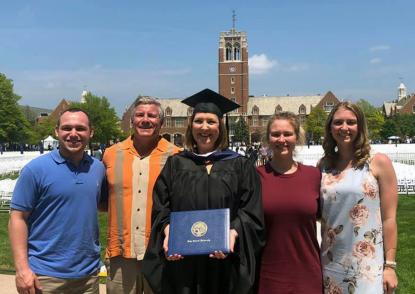 Colleen Corrigan Day stands on the quad with her family on commencement day