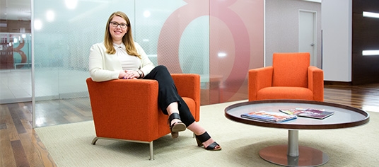 Female student featured in the lobby of her office building