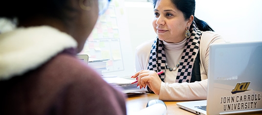 Female faculty member advising a female student 