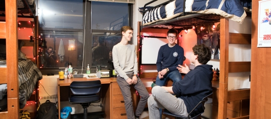 Students chatting in their residence hall room