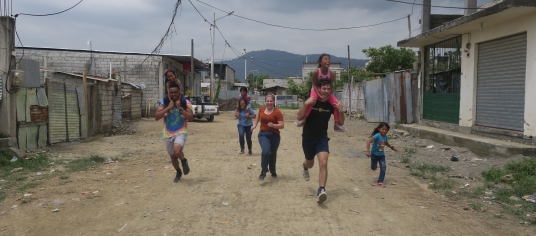 Students playing with children on an Immersion Trip.